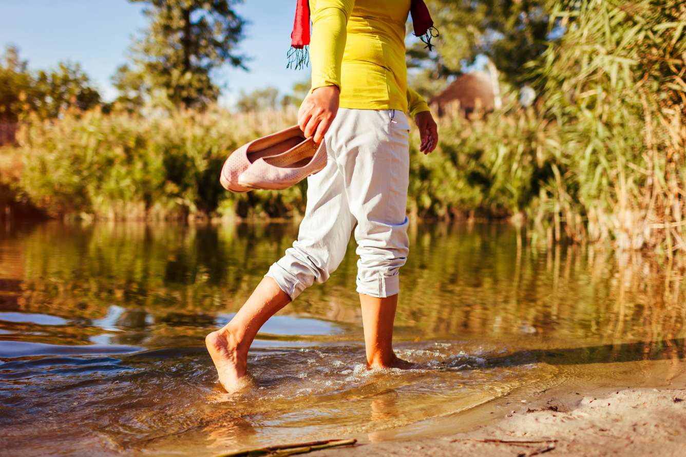 Middle-aged woman walking through puddle