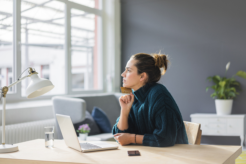Woman at work thinks about financial wellbeing