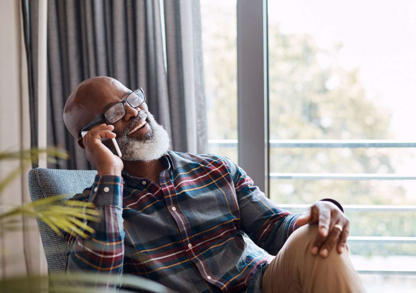 Elderly man enjoying a telephone call in his home
