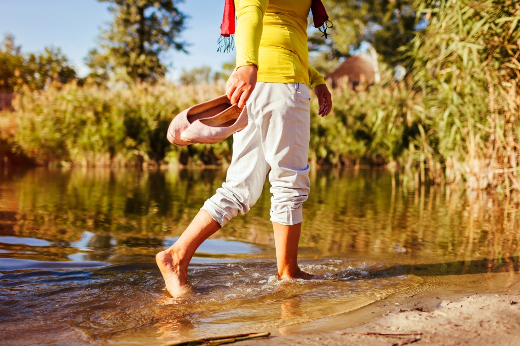 Middle-aged woman walking through puddle