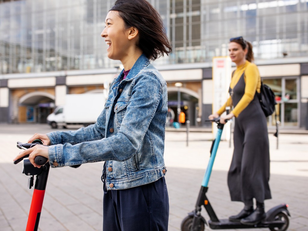 Women using environmentally friendly scooters