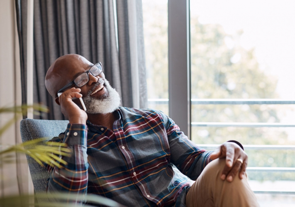 Elderly man enjoying a telephone call in his home